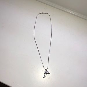 A silver dolphin necklace